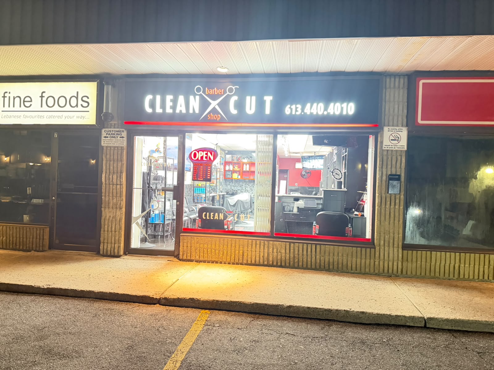 Clean Cut Barber Shop storefront on Bank St at night